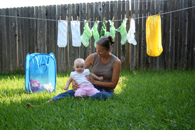 Grammy and Emma hanging diapers on the line
